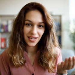Headshot of young smiling woman having video call at home Headshot of young smiling woman having video call at home